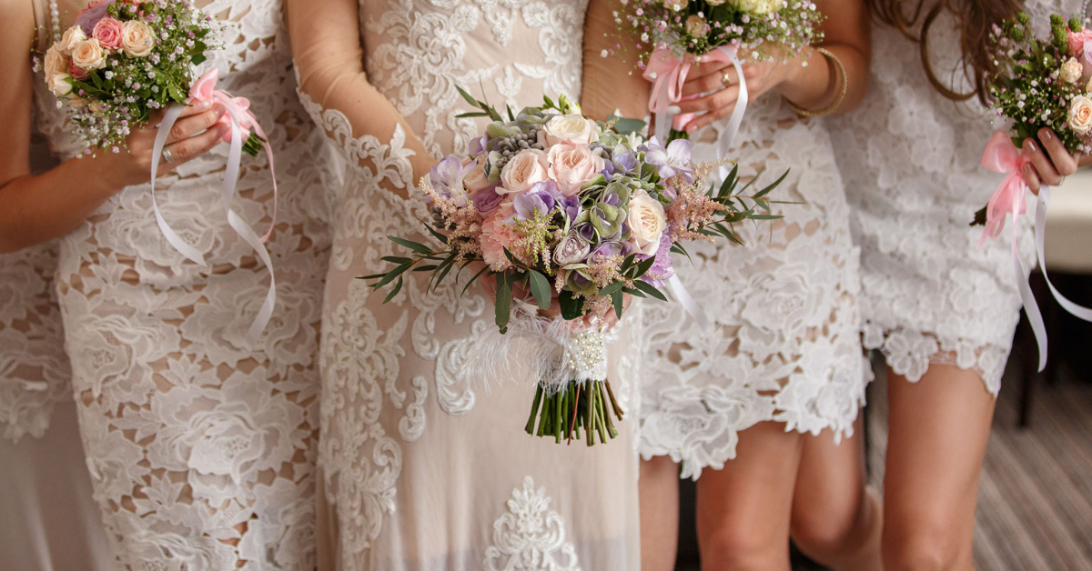 bride and bridesmaids al in white rose eyelet dresses - lafayette la banquet halls - wedding venues - reception halls