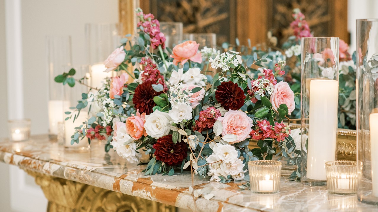 Beautiful floral arrangement and candles on a mantel at Le Pavillon - wedding and receptions spaces in Lafayette La 
