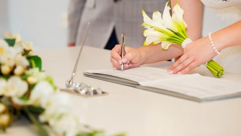image of wedding couple signing the marriage license - reception venues lafayette la - le pavillon at parc lafayete