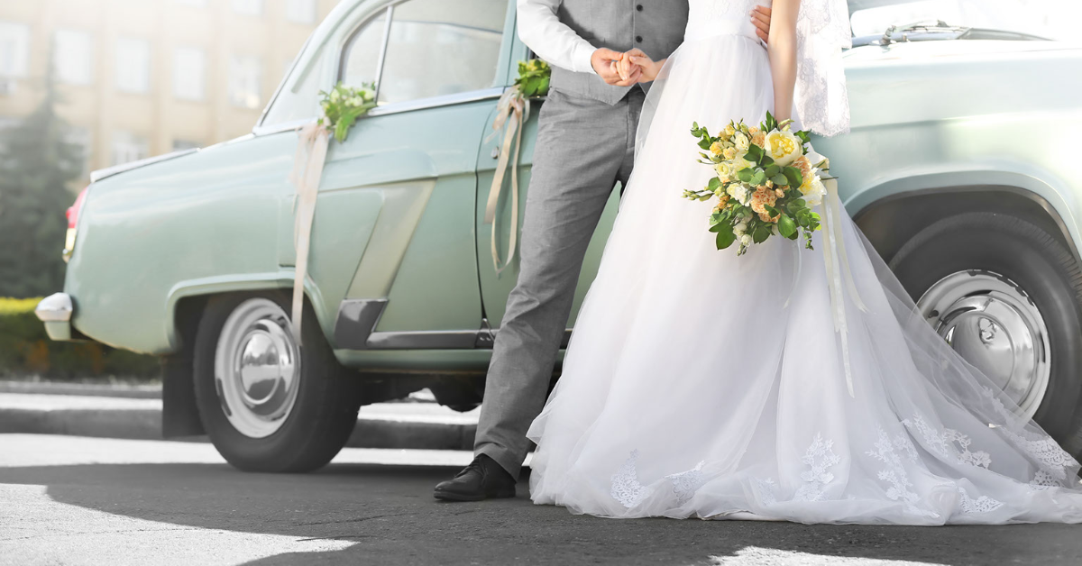 image of bride and groom in front of their departure vehicle - Lafayette Wedding Venues